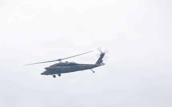 Helicopters land at a FARP site