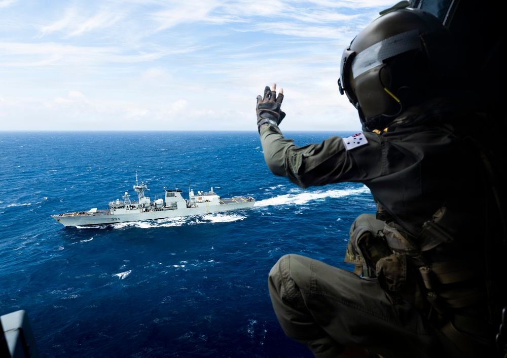 Multinational ships conduct a replenishment at sea during RIMPAC 2026