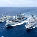 Multinational ships conduct a replenishment at sea during RIMPAC 2026
