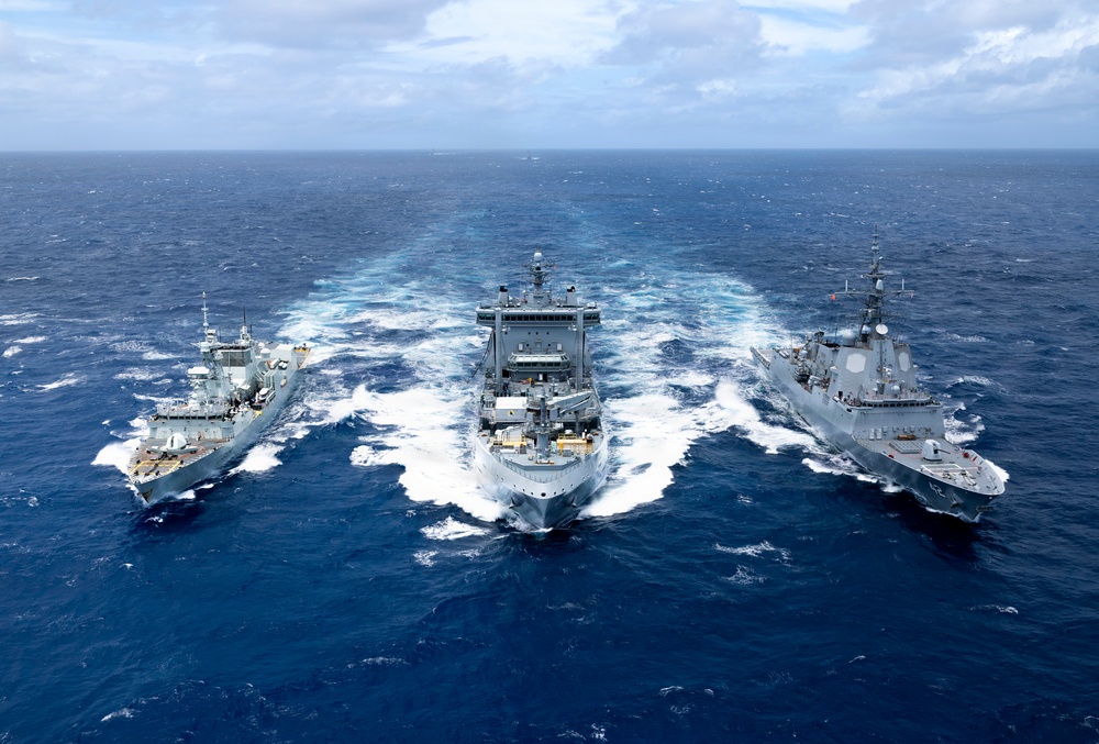 Multinational ships conduct a replenishment at sea during RIMPAC 2026