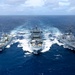 Multinational ships conduct a replenishment at sea during RIMPAC 2026