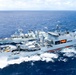 Multinational ships conduct a replenishment at sea during RIMPAC 2026