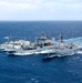 Multinational ships conduct a replenishment at sea during RIMPAC 2026