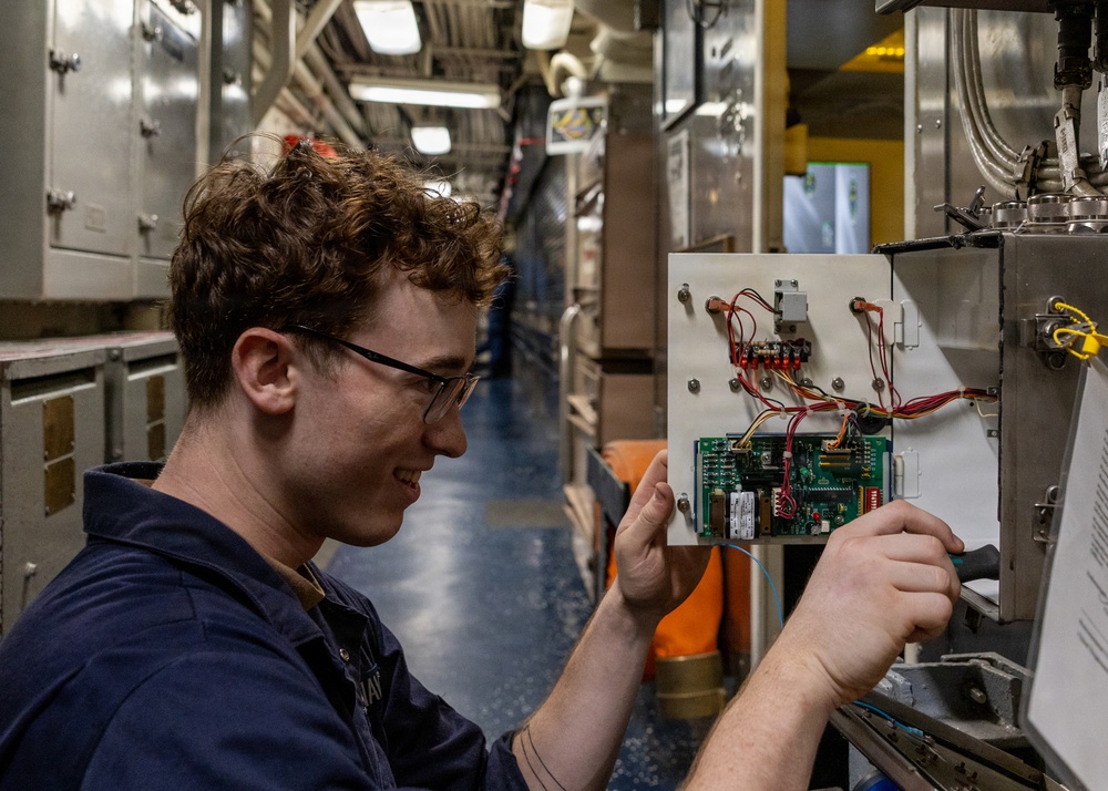 U.S. Navy Sailor Performs Electrical Maintenance Aboard Naval Vessel