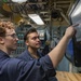 U.S. Navy Sailors Review Display Screen Aboard Naval Vessel