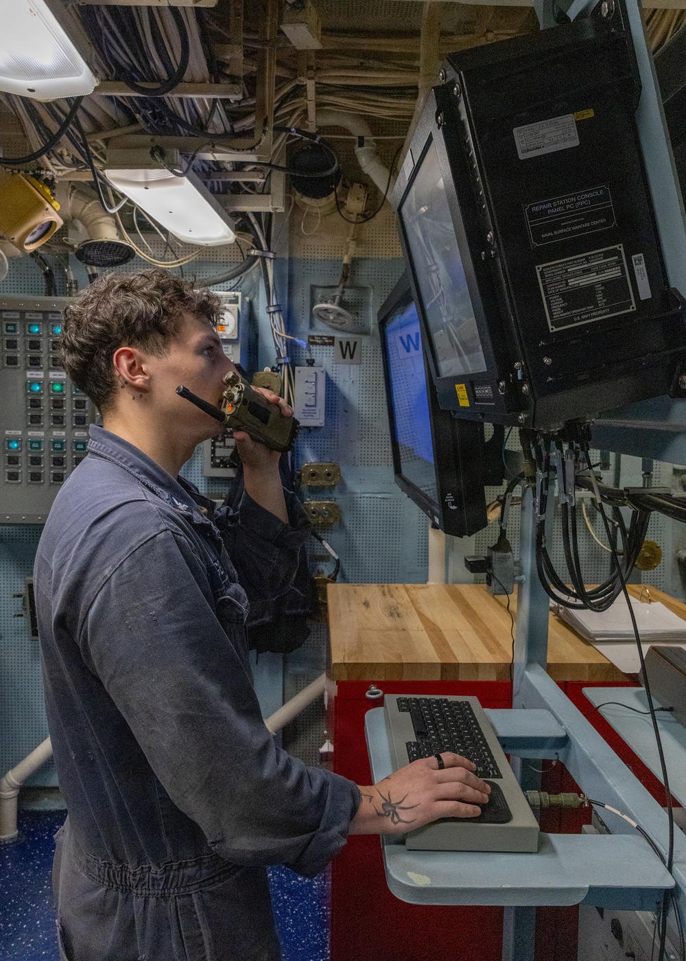 U.S. Navy Sailor Operates Console Aboard Naval Vessel