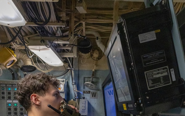 U.S. Navy Sailor Operates Console Aboard Naval Vessel