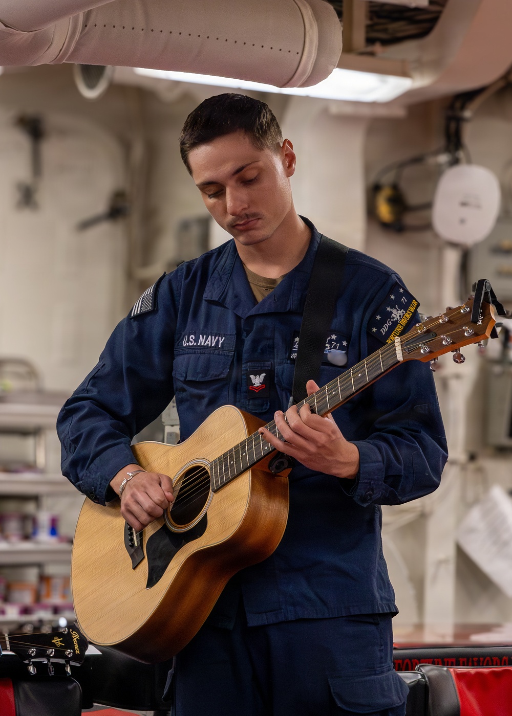 U.S. Navy Sailor Plays Acoustic Guitar Aboard Warship