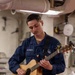U.S. Navy Sailor Plays Acoustic Guitar Aboard Warship