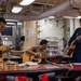 Navy sailors practice guitar during a protestant divine service