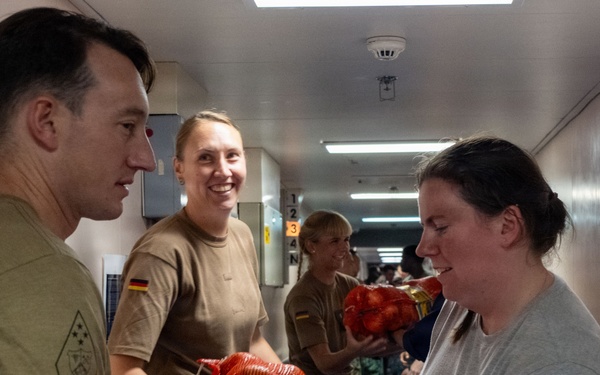 Pacific Partnership 2026 personnel embarked aboard Royal Australian Navy HMAS Choules (L100) move cargo during replenishment-at-sea