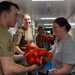 Pacific Partnership 2026 personnel embarked aboard Royal Australian Navy HMAS Choules (L100) move cargo during replenishment-at-sea