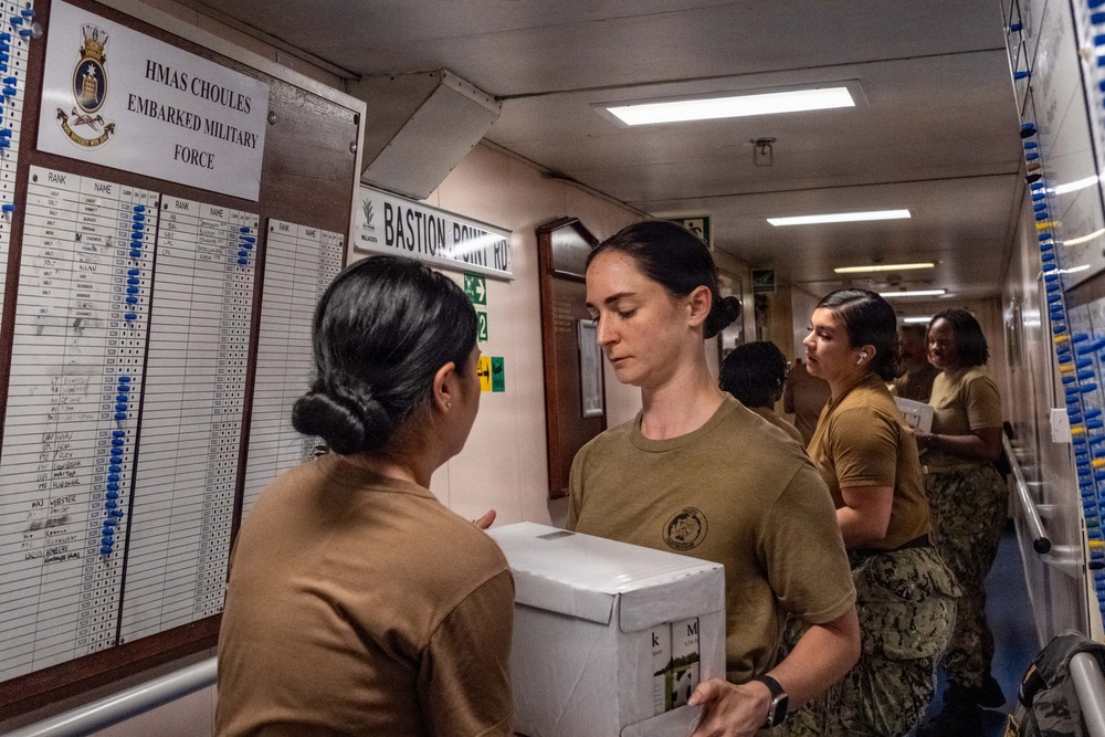 Pacific Partnership 2026 personnel embarked aboard Royal Australian Navy HMAS Choules (L100) move cargo during replenishment-at-sea