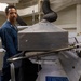 U.S. Navy Sailor Operates Laundry Equipment Aboard Naval Vessel