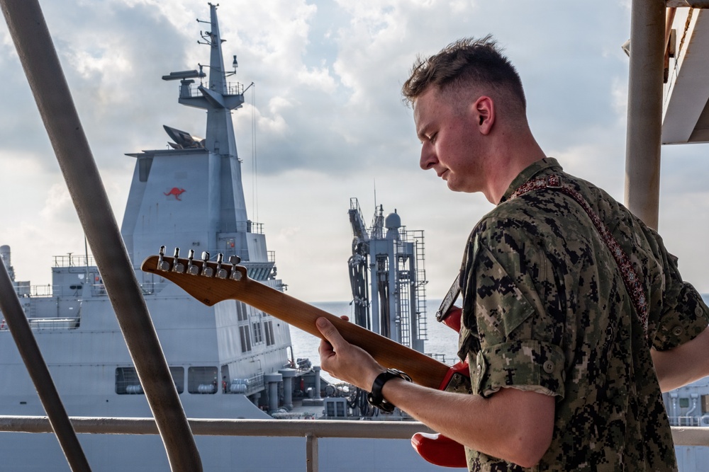 Pacific Partnership Band plays aboard Royal Australian Navy HMAS Choules (L100) during replenishment-at-sea