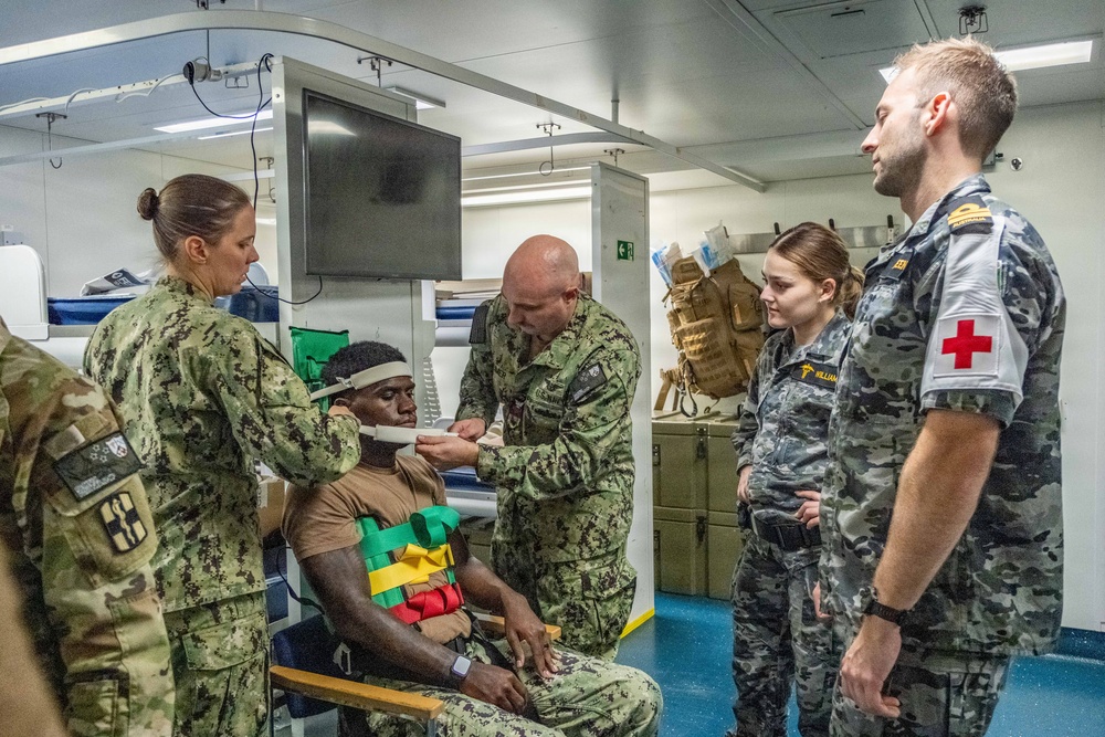 Royal Australian Navy medics train Pacific Partnership 2026 medical personnel on extrication device aboard HMAS Choules (L100)