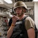 U.S. Navy Sailor Communicates via Radio Aboard Naval Vessel During Operations