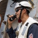 U.S. Navy Sailor Communicates via Radio Aboard Naval Vessel