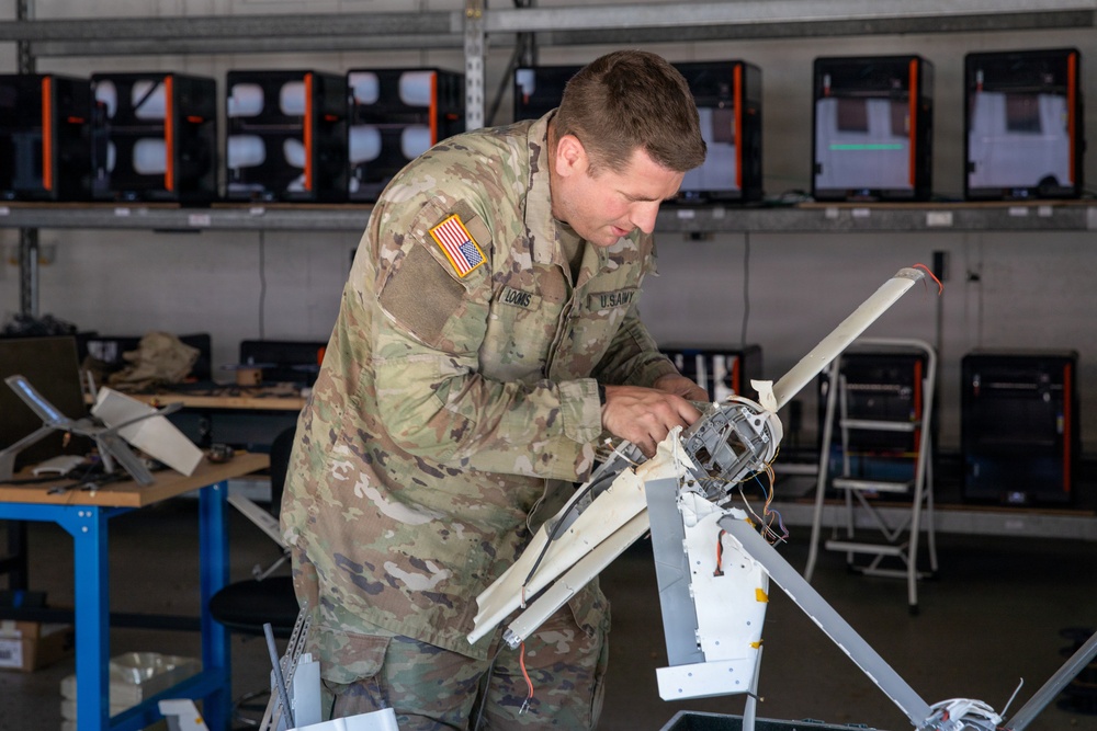 21st Theater Sustainment Command Soldier Evaluates Salvaged Drone Components