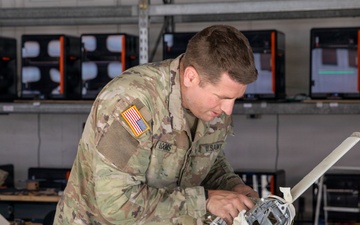 21st Theater Sustainment Command Soldier Evaluates Salvaged Drone Components