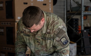 21st Theater Sustainment Command Soldier Evaluates Salvaged Drone Components