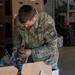 21st Theater Sustainment Command Soldier Evaluates Salvaged Drone Components