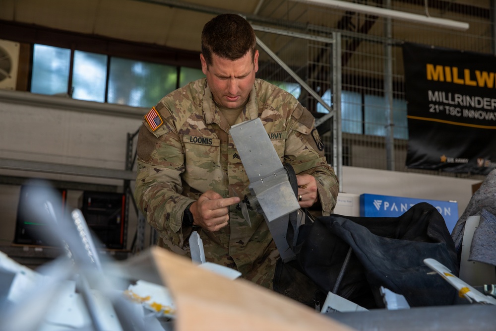 21st Theater Sustainment Command Soldier Evaluates Salvaged Drone Components