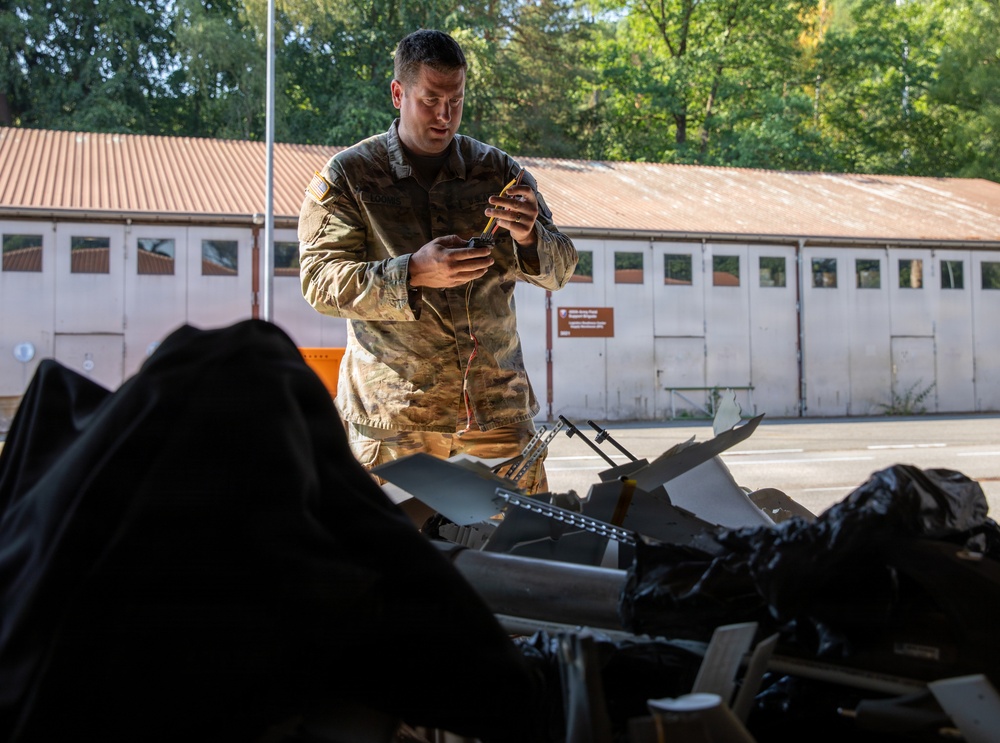 21st Theater Sustainment Command Soldier Evaluates Salvaged Drone Components