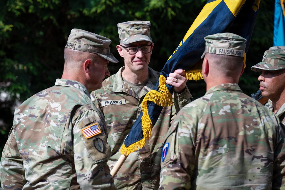 Col. Fausnaugh passes guidon to Col. Peterson at 19th BCD Change of Command