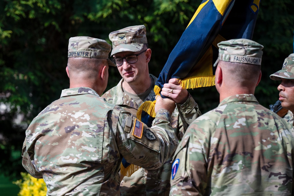 Col. Fausnaugh passes guidon to Col. Peterson at 19th BCD Change of Command
