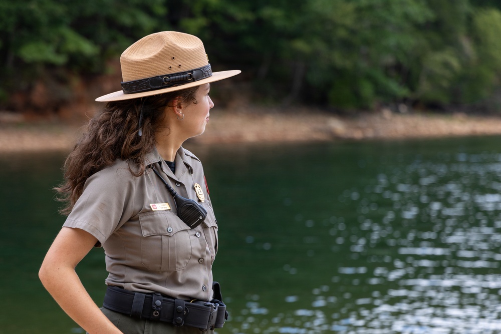 U.S. Army Corps of Engineers park ranger surveys lake shoreline during patrol operations