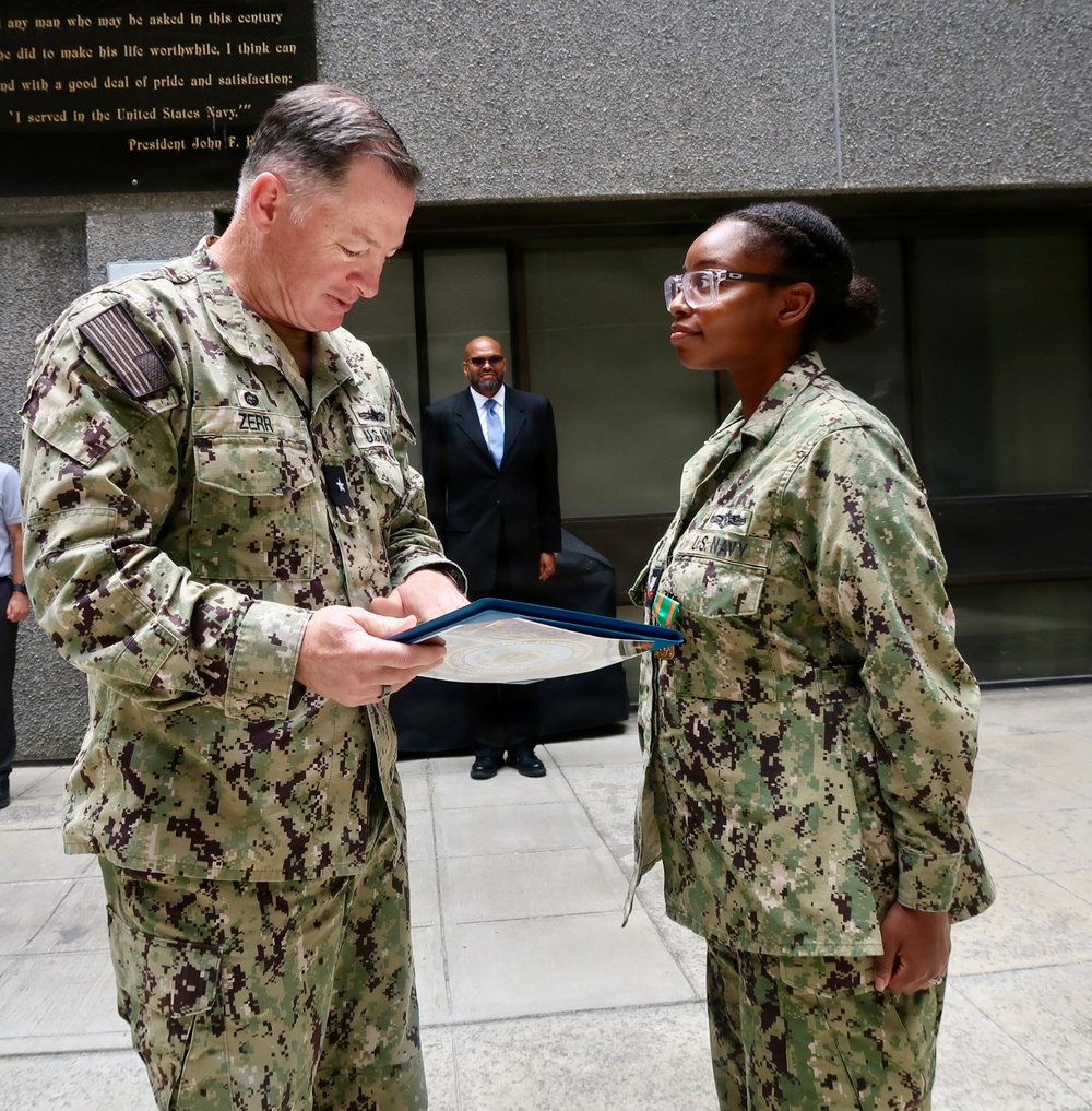 Rear Adm. T.J. Zerr presents IS2 Amaya Yuille with the Junior Sailor of the Year Award