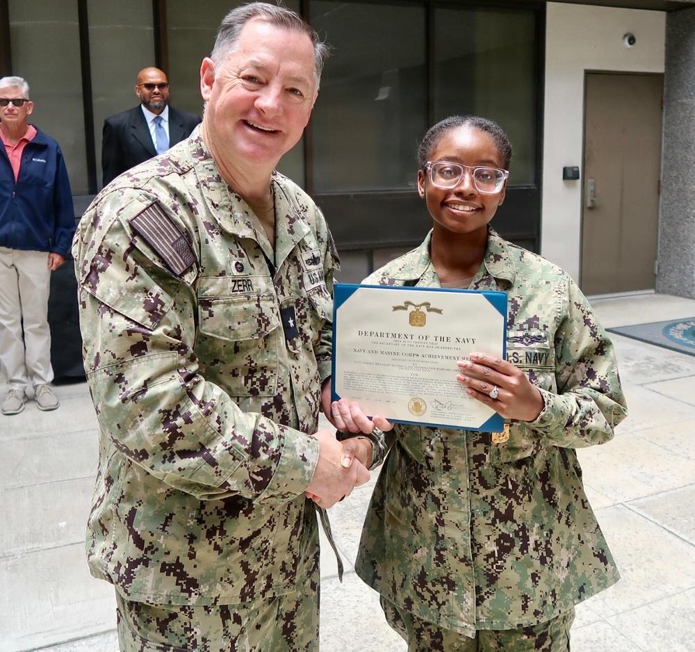 Rear Adm. T.J. Zerr presents IS2 Amaya Yuille with the Junior Sailor of the Year Award