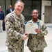 Rear Adm. T.J. Zerr presents IS2 Amaya Yuille with the Junior Sailor of the Year Award