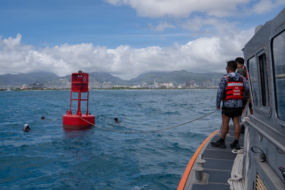 Partner nations participate in a buoy restoration project during RIMPAC 26