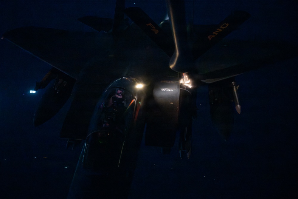 KC-135 refuels F-15s during night operations in CENTCOM AOR