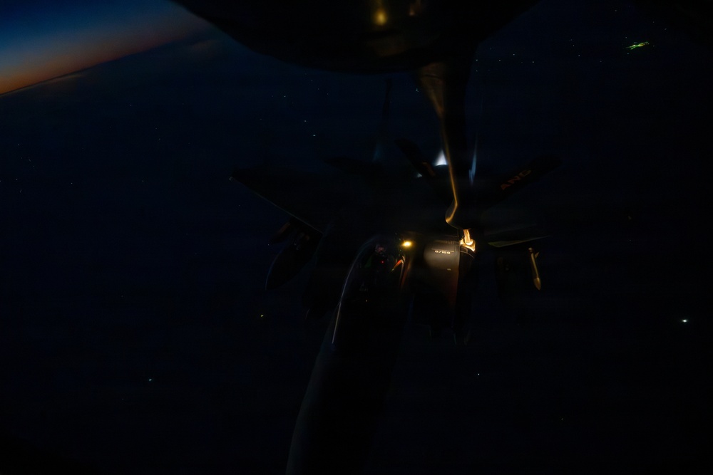 KC-135 refuels F-15s during night operations in CENTCOM AOR