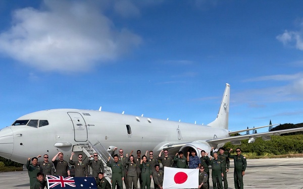 Japan Maritime Self-Defense Force and Royal Australian Navy aviation personnel pose for a group photo during RIMPAC 2026