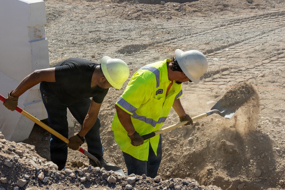 Base Maintenance and Engineering Department work to repair a washed-out section of Range Road aboard Marine Corps Logistics Base Barstow,