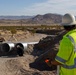 Personnel with the Base Maintenance and Engineering Department work to repair a washed-out section of Range Road aboard Marine Corps Logistics Base Barstow