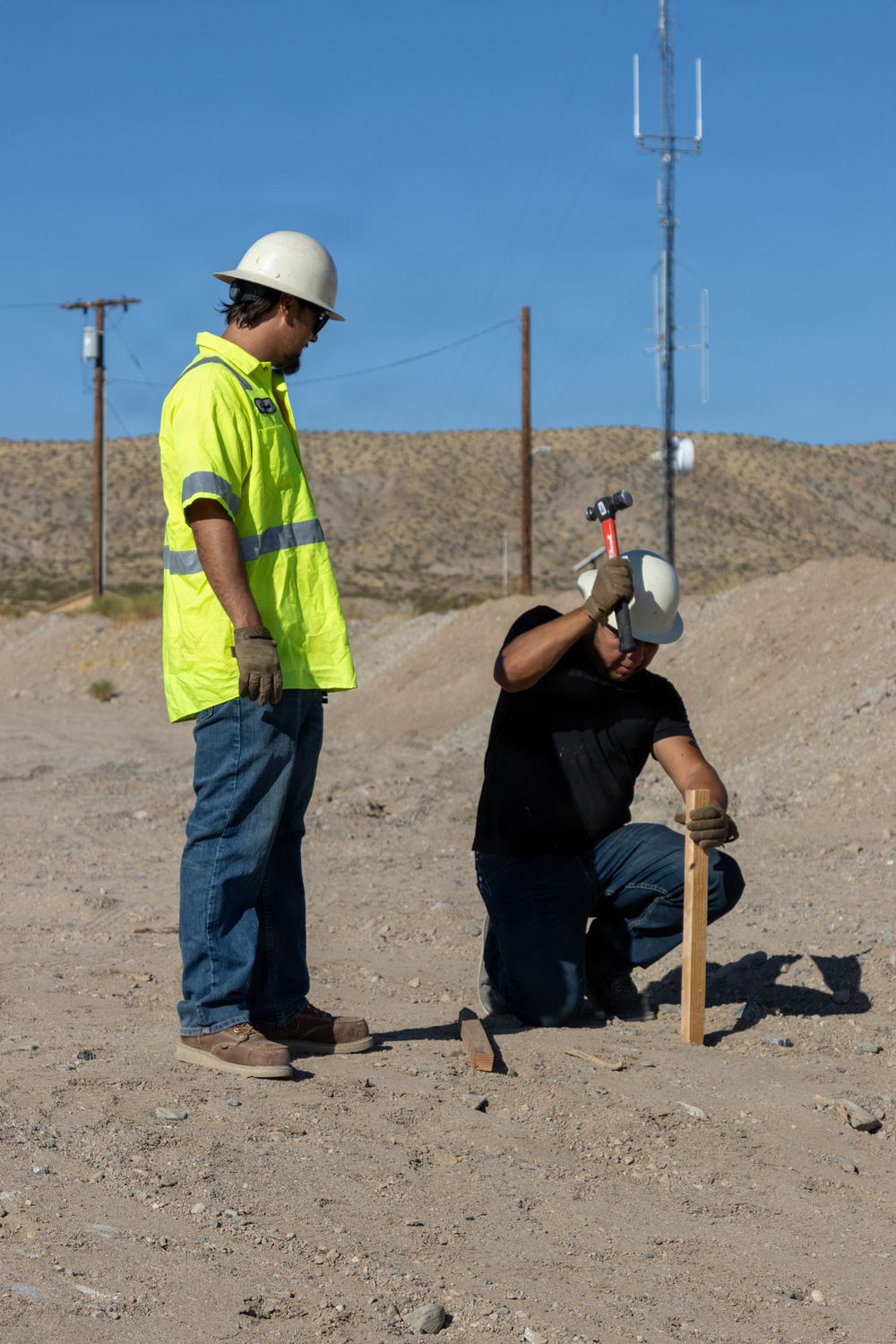 Base Maintenance and Engineering Department work to repair a washed-out section of Range Road aboard Marine Corps Logistics Base Barstow