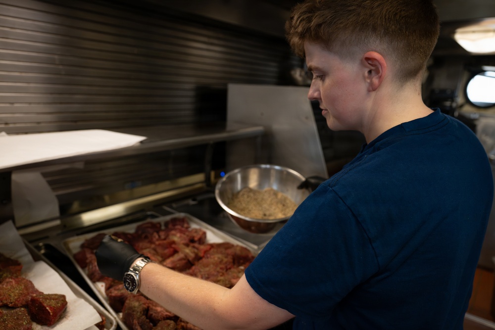 USCGC Eagle culinary specialists prepare a meal at sea