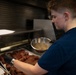 USCGC Eagle culinary specialists prepare a meal at sea