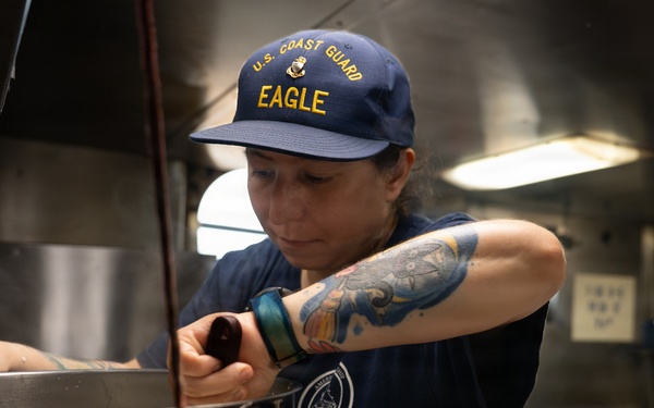 USCGC Eagle culinary specialists prepare a meal at sea