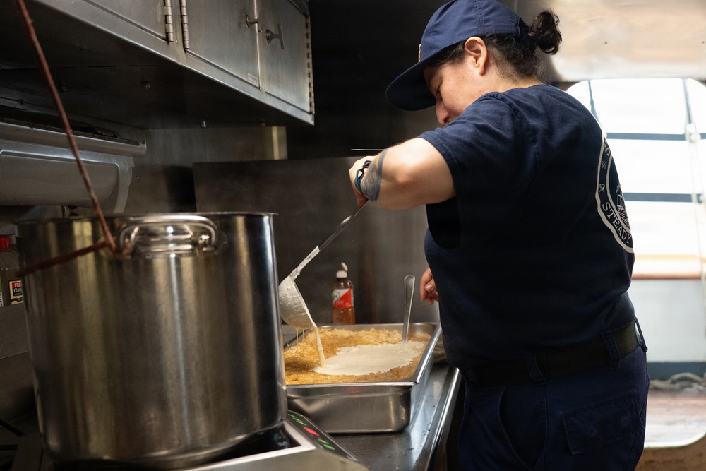 USCGC Eagle culinary specialists prepare a meal at sea