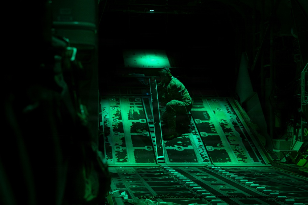 AFSOC MC-130J conducts nighttime air drops