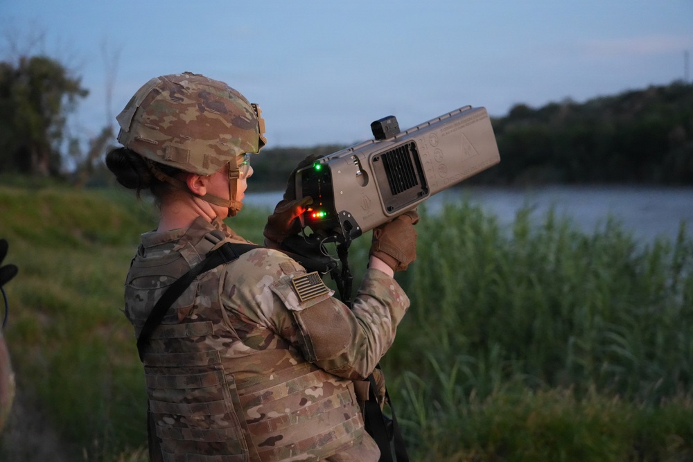 U.S. Army Soldiers with the 1729th Support Maintenance Company demonstrate the Dronebuster