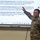 2026 Paralegal Warrior A US Army soldier in OCP (Operational Camouflage Pattern) uniform is presenting a briefing in front of a large interactive display screen. The presentation appears to cover legal and administrative topics related to military separation packets, JAG oversight, and paralegal responsibilities. The setting appears to be a classroom or training room environment.