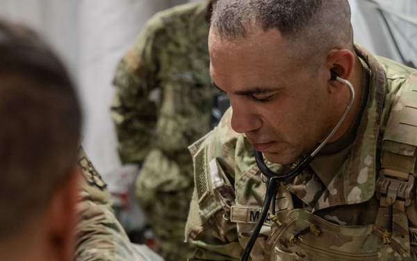 Global Medic Personnel Treat Simulated Casualty