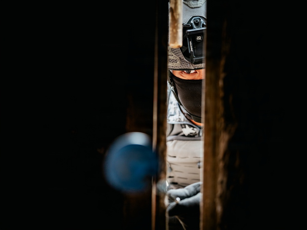 Multinational EOD technicians participate in an IED response drill